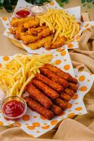 french fries with chicken nuggets and sauces photo