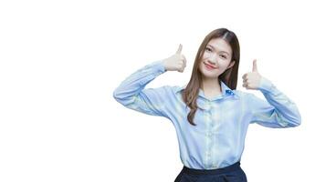 Beautiful young business female who has long hair Asian with blue shirt smiles and shows thumb up to present something while isolated on white background. photo