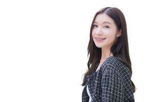 Portrait of beautiful long haired young Asian woman in black pattern coat with braces on teeth walking and smiling while isolated on white background. photo