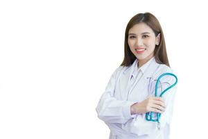 Professional young Asian woman doctor standing with arms crossed happy and smile in hospital. Wearing white robe and stethoscope while isolated on white background. photo