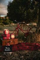 Christmas shoot in the countryside with vintage suitcase and Christmas gifts. photo