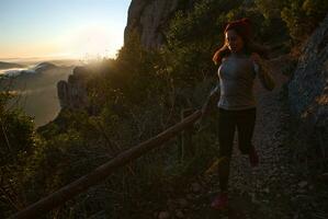 Woman runs through the mountains of Montserrat in Catalonia, Spain. photo