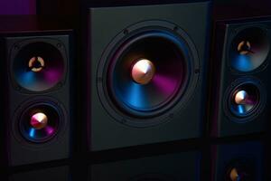 Two sound speakers and subwoofer on dark background with neon lights photo