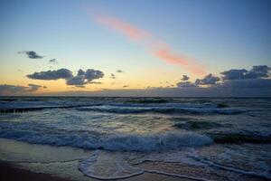 Baltic sea against dramatic cloudy sky at sunset photo