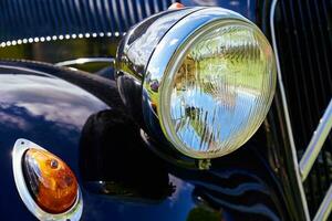 Retro car headlight. Classic car detail photo