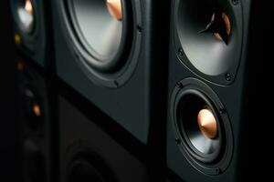 Two sound speakers and subwoofer on dark background photo