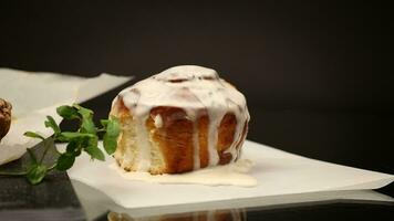cooked baked sweet cinnabon with cream on black background video
