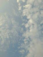 Beautiful white clouds on deep blue sky background. Large bright soft fluffy clouds are cover the entire blue sky. Skyscape on Lombok Island, Indonesia photo