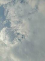 Beautiful white clouds on deep blue sky background. Large bright soft fluffy clouds are cover the entire blue sky. Skyscape on Lombok Island, Indonesia photo