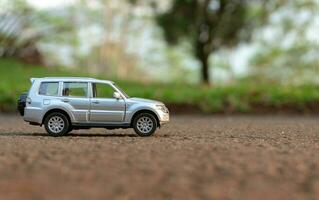 Concept for traveling and outdoor activities. Photo of a toy car on the road. After some edits.