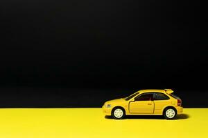 Yellow toy car isolated on multicolored background. After some edits. photo