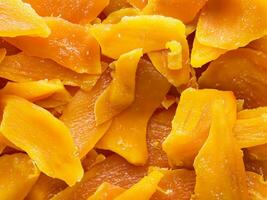 dried mango slices on white background. close up photo