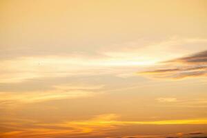 Beautiful of luxury soft gradient orange gold clouds and sunlight on the blue sky perfect for the background, take in everning,Twilight photo