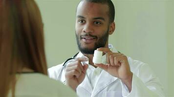 Smiling doctor showing a patient a drug video