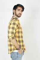 a man in a yellow and black checkered shirt photo