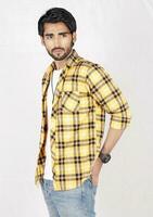 a man in a yellow and black checkered shirt photo