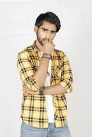 a man in a yellow and black checkered shirt photo