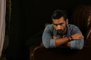 a man standing in front of a couch photo