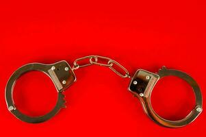 handcuffs on a red background photo