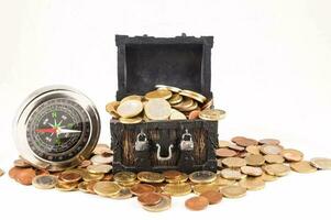 a chest full of coins and a compass photo