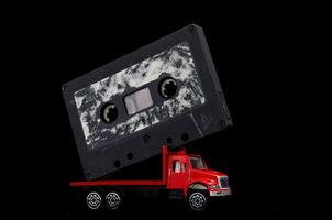 a red truck with a cassette on top of it photo