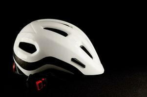 a white bicycle helmet on a black background photo