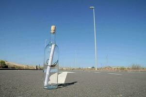 a message in a bottle on the road photo