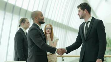 Friendly handshake between two successful businessmen video
