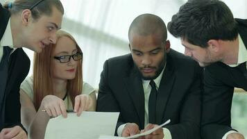 Businessmen sitting at table in office while discussing their of business doings video