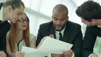 Businessmen sitting at table in office while discussing their of business doings video