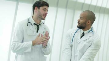 Two young doctors in medical gown lively debating video