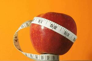 an apple with a measuring tape around it photo