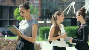 Business woman working on a tablet then briefly smiling at the camera video