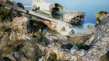 Plane wreck on the beach with rocks near ocean video