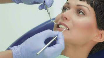 Dentist teeth carefully examines the patient girl video