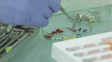 Dentist puts himself and the girl lying in the dental chair protective red glass video