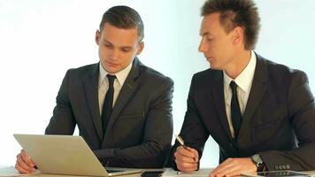 Businessmen discussing the business plan for the laptop screen video