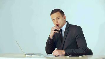 Young businessman listens attentively to his companion then tells him video