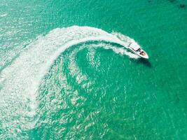 Aerial view of Speed boat at high speed in the aqua sea, Drone view photo