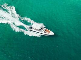 Aerial view of Speed boat at high speed in the aqua sea, Drone view photo