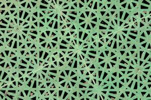 a green lattice pattern with holes in it photo