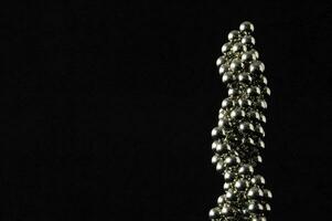 a close up of a metal sculpture with many balls photo