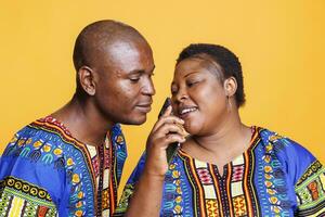 Man and woman couple using mobile phone as microphone. African american singers singing together in smartphone mic, recording song with telephone voice recorder application photo
