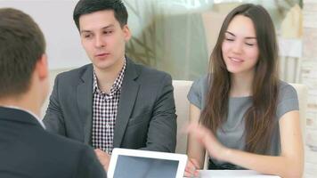 Young attractive couple consults about their business project video