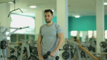 Young man doing exercise 2 with dumbbells video