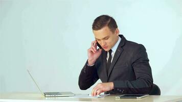 Young businessman making a call on the phone video