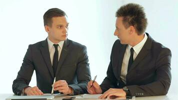 Businessmen sitting at a table video