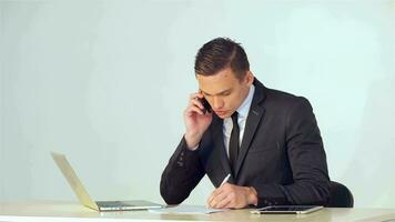 Young businessman making notes in a notebook video