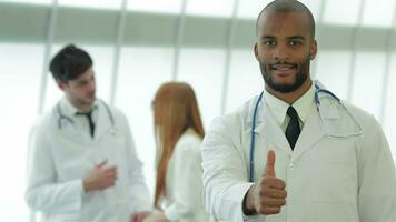 Portrait of a successful doctor showing two thumbs up video