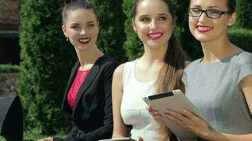 Three successful female business partner turns to the camera and smiling video